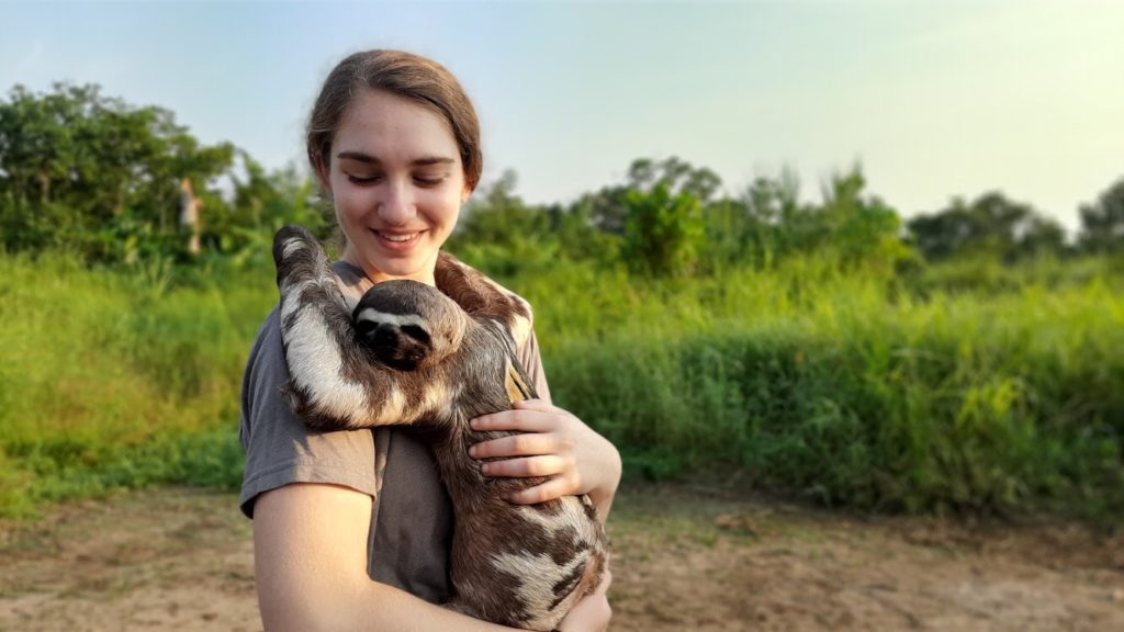 Sarah holding a sloth named Pablo.