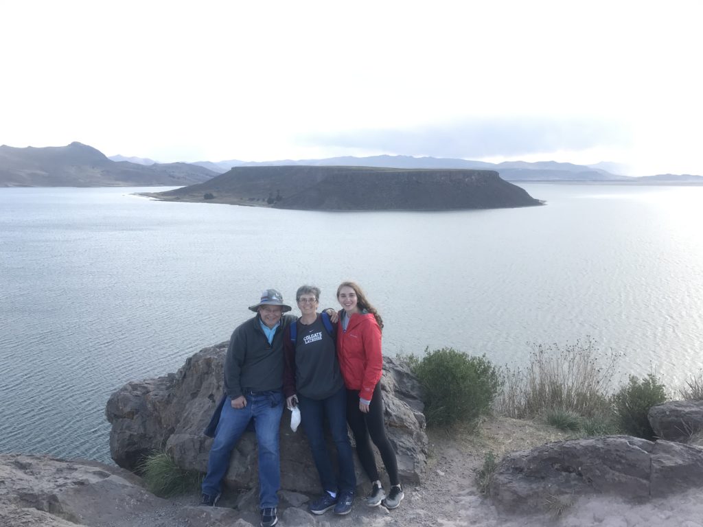 Sarah and her parents standing in front of a lagoon at Sillustani, a pre-incan burial sight