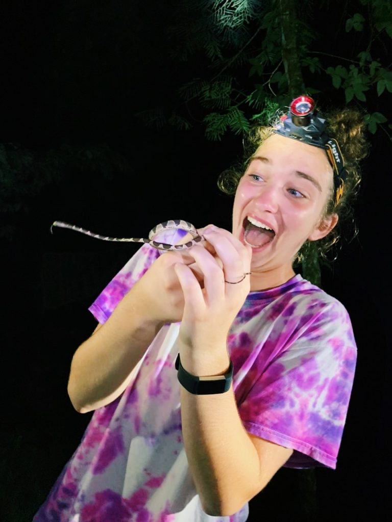 holding a snake and a funny face